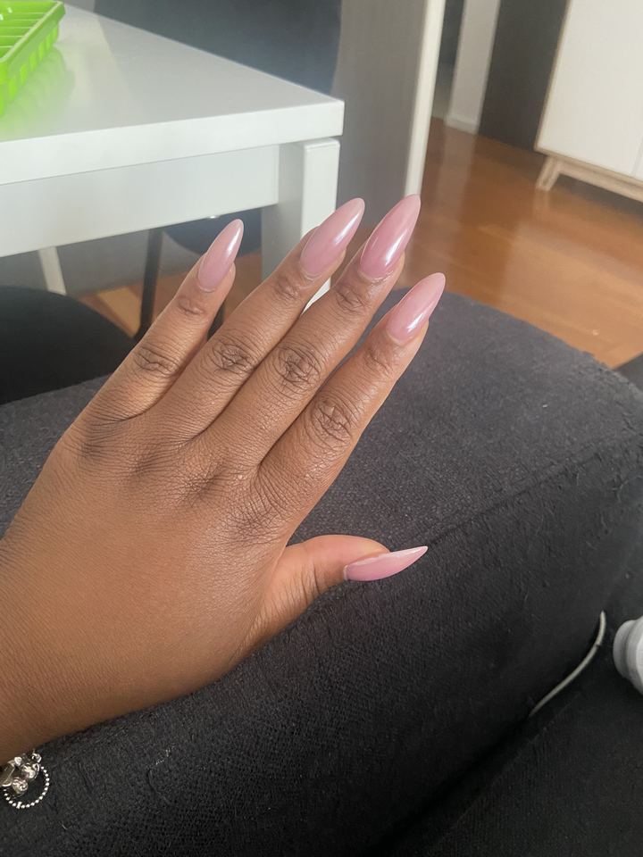 Long almond nails in soft pink with a pearly chrome finish